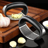 Stainless steel garlic press crusher and manual mincer for chopping garlic, fruits, and vegetables – durable kitchen tool and accessory.